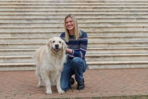 Student with a dog on campus. Photo by Catherine White | The Cavalier Daily